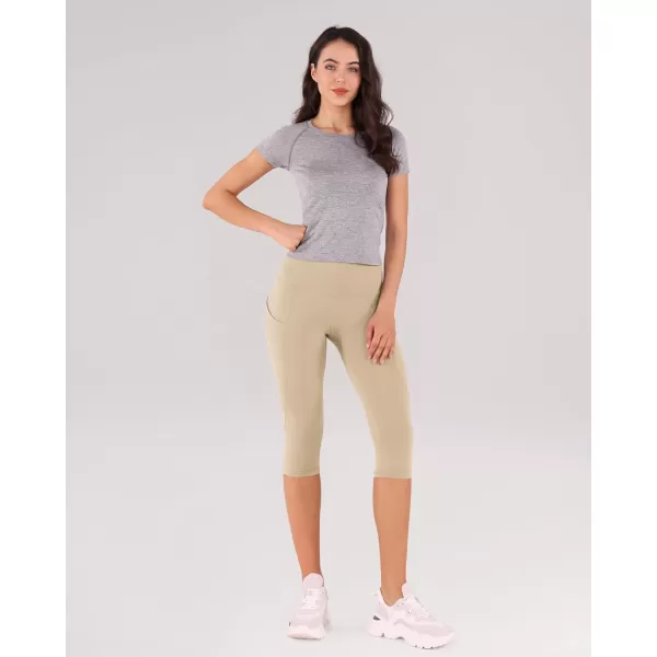 imageODODOS Womens High Waisted Yoga Capris with Pockets Tummy Control Non See Through Workout Athletic Running Capri LeggingsBeige