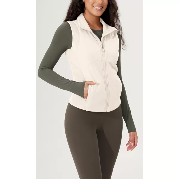 imageODODOS Womens Padded Vest with Pockets Athletic Stand Collar Sleeveless Warm Outerwear Zip Up GiletWhite