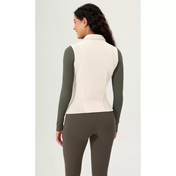 imageODODOS Womens Padded Vest with Pockets Athletic Stand Collar Sleeveless Warm Outerwear Zip Up GiletWhite