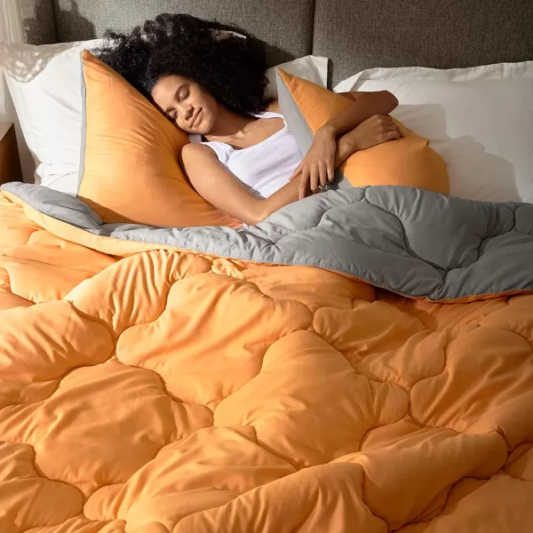 Comfort Spaces Vixie Reversible Comforter Set  Trendy Vibrant Color with Geometric Quilted Cover Lightweight All Season Down Alternative Cozy Bedding Sham NavyCharcoal TwinTwin XL 2 pieceOrangeGrey