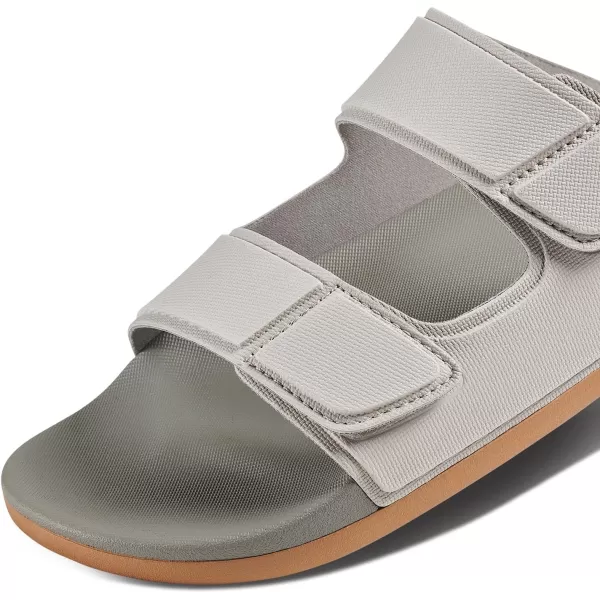 imageREEF Cushion Tradewind Mens Fashion Slides Adjustable Velcro Straps Ultra Soft Cushion Footbed Arch SupportDoveTobacco