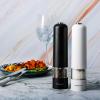 imageOVENTE Set of 2 Electric Salt ampamp Pepper Mill Grinder Battery Powered Stainless Steel Blades Automatic One Handed Operation with light and Adjustable Coarseness Black and White SPD102BW