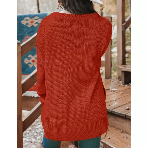 imageZESICA Womens 2023 Casual V Neck Sweater Loose Long Sleeve Waffle Knit Button Henley Pullover Jumper TopOrange