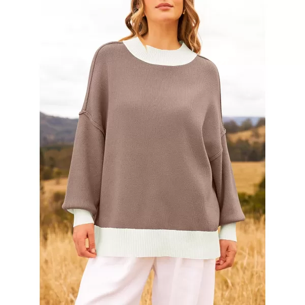 imageZESICA Womens Winter Oversized Sweaters Long Sleeve Color Block Mock Neck Side Slit Comfy Loose Knitted Pullover TopsAlmond